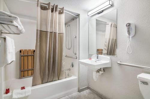 a white bathroom with a sink and a shower at SureStay Hotel by Best Western Lewiston in Lewiston