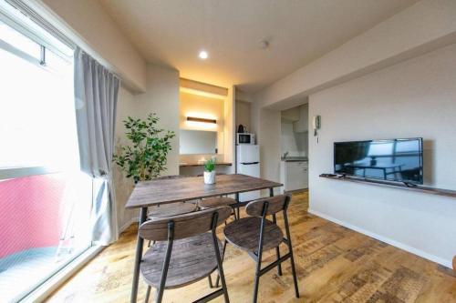 a dining room with a table and two chairs at Early Arc Osaka in Osaka