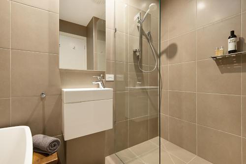 a bathroom with a shower and a toilet and a sink at Salt Loft in Queenscliff