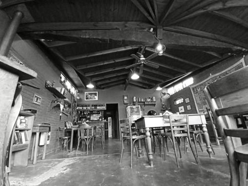 a room with chairs and tables in a restaurant at el refugio piramides in Puerto Pirámides