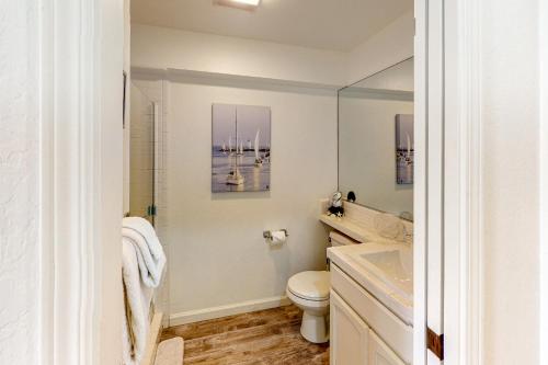 a bathroom with a toilet and a sink and a mirror at Oceanview Paradise in Watsonville
