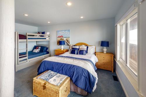 a bedroom with a bed with a blue comforter at Oceanview Paradise in Watsonville