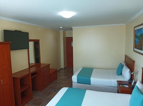 Ένα ή περισσότερα κρεβάτια σε δωμάτιο στο Hotel El Marqués