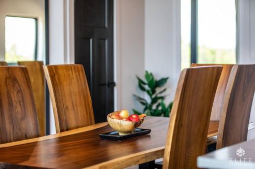 a bowl of fruit sitting on a wooden table at Luxury Living at The Eagles Perch Palmer AK in Palmer