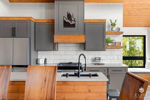 a kitchen with gray cabinets and a sink at Luxury Living at The Eagles Perch Palmer AK in Palmer