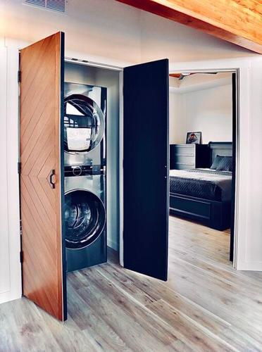 a washer and dryer in a room with a bedroom at Luxury Living at The Eagles Perch Palmer AK in Palmer