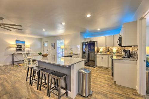 a large kitchen with a counter and stools at Pet-Friendly Digs with Fire Pit and Large Yard! in Fayetteville