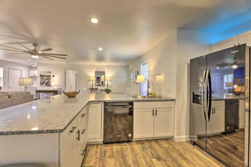 a kitchen with white cabinets and a counter top at Pet-Friendly Digs with Fire Pit and Large Yard! in Fayetteville