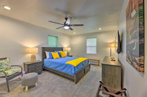 a bedroom with a bed and a ceiling fan at Pet-Friendly Digs with Fire Pit and Large Yard! in Fayetteville