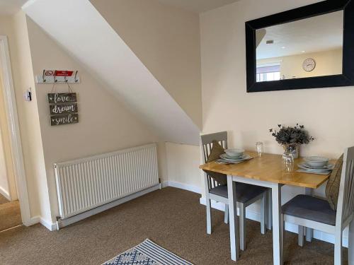 a dining room with a table and a mirror at Beautiful 1 Bed Apartment in the Heart of Ludlow in Ludlow