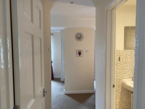 a hallway of a bathroom with a sink and a mirror at Beautiful 1 Bed Apartment in the Heart of Ludlow in Ludlow