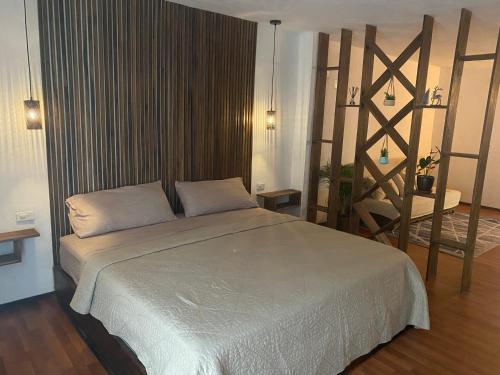 a bedroom with a large bed in a room at Suite La Patera & El colibri in Ayampe