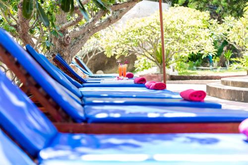 a row of blue beach loungers sitting on a table at Crystal Bay Yacht Club Beach Resort in Lamai
