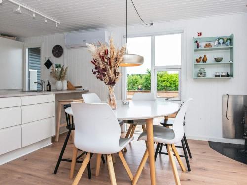 a kitchen and dining room with a table and chairs at 8 person holiday home in Struer-By Traum in Struer