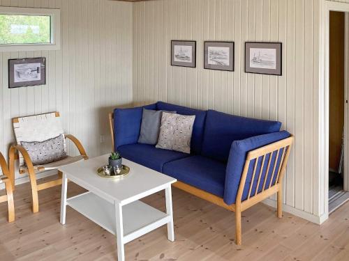 a living room with a blue couch and a table at 6 person holiday home in Thyholm-By Traum in Thyholm