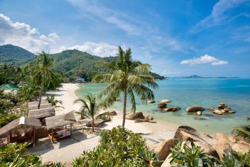 a beach with chairs and palm trees and the ocean at Crystal Bay Yacht Club Beach Resort in Lamai