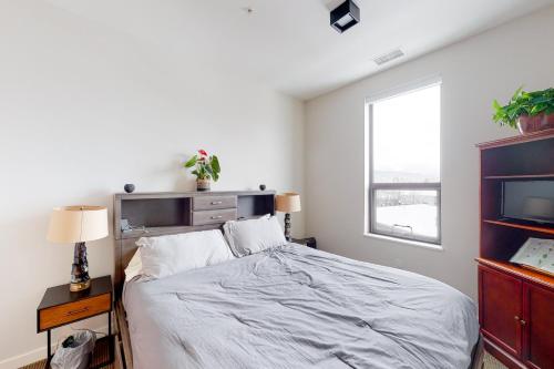 a bedroom with a large bed and a window at Aspen Crossing in Bozeman