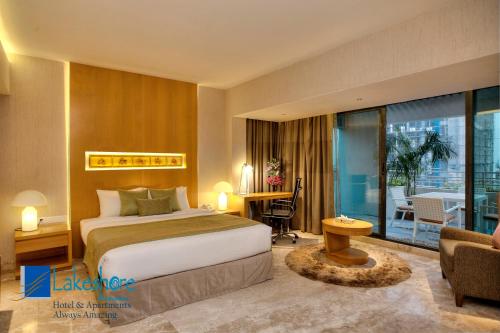 a hotel room with a bed and a balcony at Lakeshore Banani in Dhaka