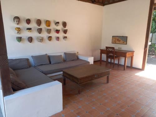 a living room with a couch and a table at Si Pitung Village in Gili Air