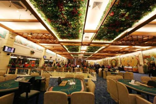 a casino with tables and chairs in a casino at Poipet Resort & Casino in Krong Poi Pet