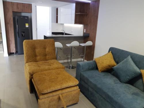 a living room with a couch and a chair at Apartamentos Edificio Premium in Paipa