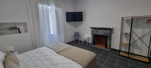 a bedroom with a bed and a fireplace at Casa Al'entejo in Ferreira do Alentejo