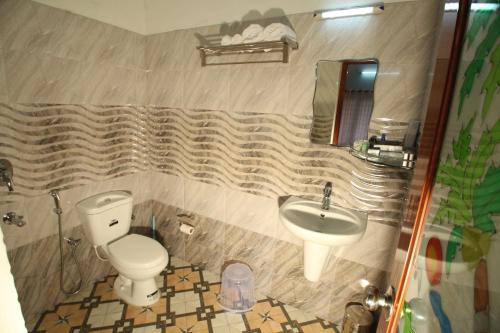 a bathroom with a toilet and a sink at Spring and Valley View in Thekkady