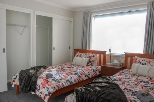 a bedroom with two beds and a window at City Centre Escape in Napier