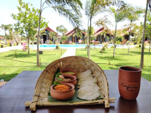 a basket of food sitting on a table with a cup at Anukama Resort in Nilaveli