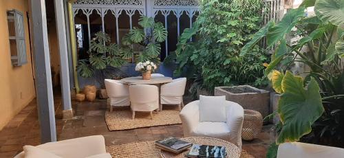 a patio with a table and chairs and plants at Candelaria House Boutique in Bogotá