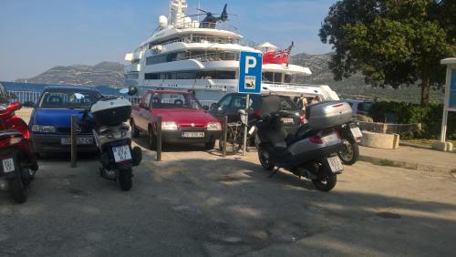 a group of motorcycles parked next to a cruise ship at in k in Korčula