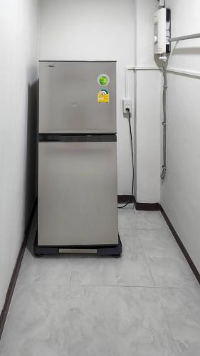 a refrigerator sitting in a room with a wall at APARTMENT A4 DINDAENG in Bangkok