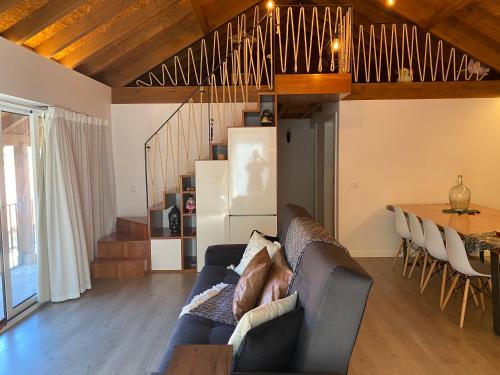 a living room with a couch and a table at Quinta da Vinha do Souto in Arouca