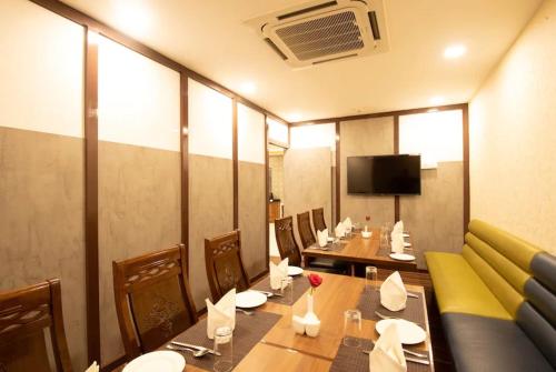 a restaurant with a dining room with tables and chairs at Blue Ocean Residency in Bangalore