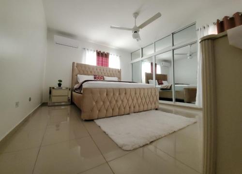 a large bedroom with a bed and a mirror at Santiago City Center Huge nice Apartment to stay rooftop to enjoy the city view in Santiago de los Caballeros
