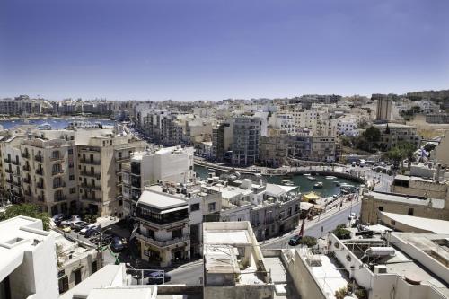 an aerial view of a city with tall buildings at Spinola Hotel in St Julian's