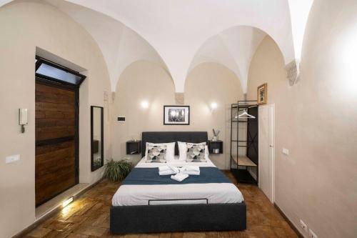 Un ou plusieurs lits dans un hébergement de l'établissement Studio delle Grotte - Campo de’ Fiori