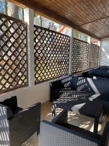 a group of chairs and tables on a patio at Claude Monet Seaside Hotel in Grigoleti
