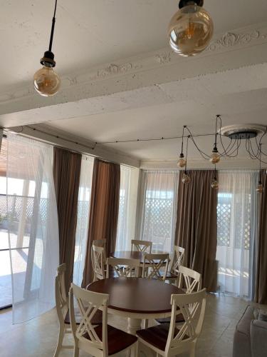 a dining room with a table and chairs at Claude Monet Seaside Hotel in Grigoleti