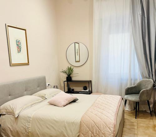 a bedroom with a bed and a mirror and a chair at Adream in Pescara