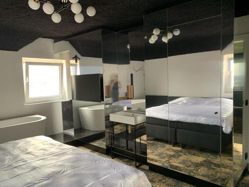 a bedroom with a bed a sink and a mirror at Bed & Breakfast Maison Noire Westende-bad incl parking & ontbijt in Middelkerke