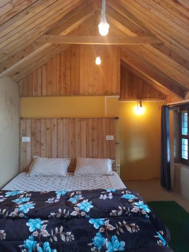 a bedroom with a bed in a room with wooden ceilings at NotOnMap- Amaira Homestay in Khajjiar 