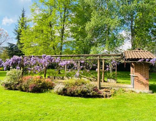 a garden with a gazebo and purple flowers at Villa Giulia - Bisalta in Peveragno