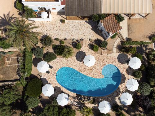 an overhead view of a pool in a landscaped yard at Agroturismo Son Juaneda in Ciutadella