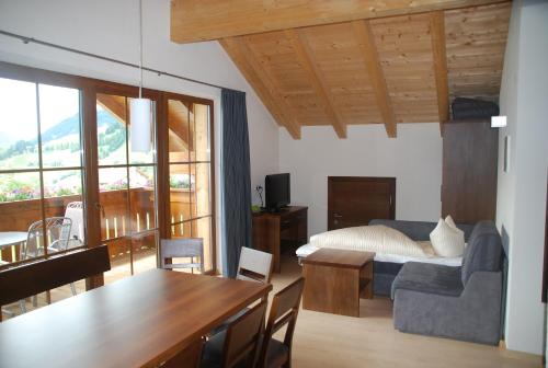 ein Wohnzimmer mit einem Bett und einem Esstisch in der Unterkunft Apart Acasa in Fiss