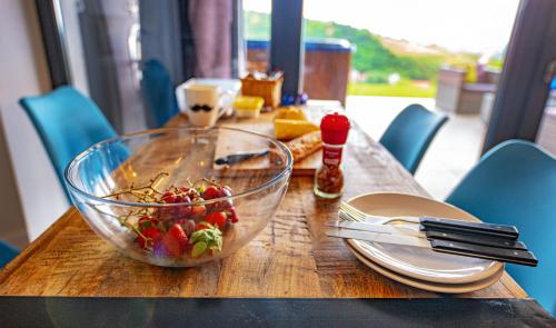 a wooden table with a bowl of fruit on it at Villa46 in Pécs