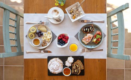 a table with breakfast foods and drinks on it at Agroturismo Son Juaneda in Ciutadella