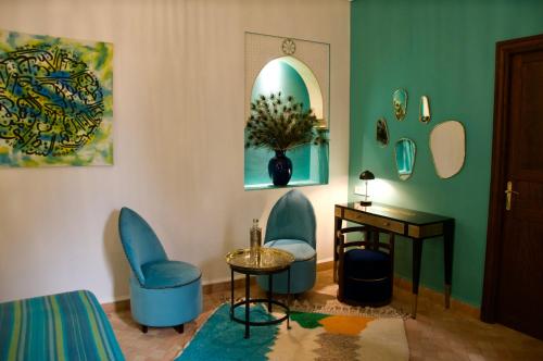 a room with two chairs and a table and a desk at La Claire Fontaine in Marrakech