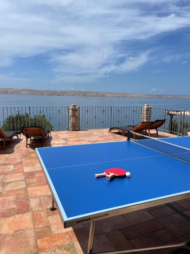 a blue ping pong table sitting on top of a patio at Family Villa Tiffany&more in Barić Draga