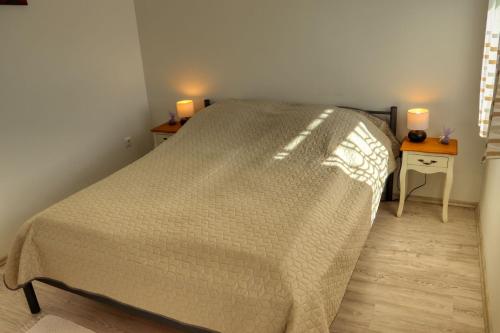 Postel nebo postele na pokoji v ubytování Mi Kertünk Apartman